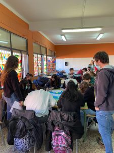 Teenagers grouped around a table in a classroom discussing the SEEDS questions