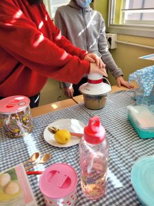 Teenage scientists using a blender to prepare snacks